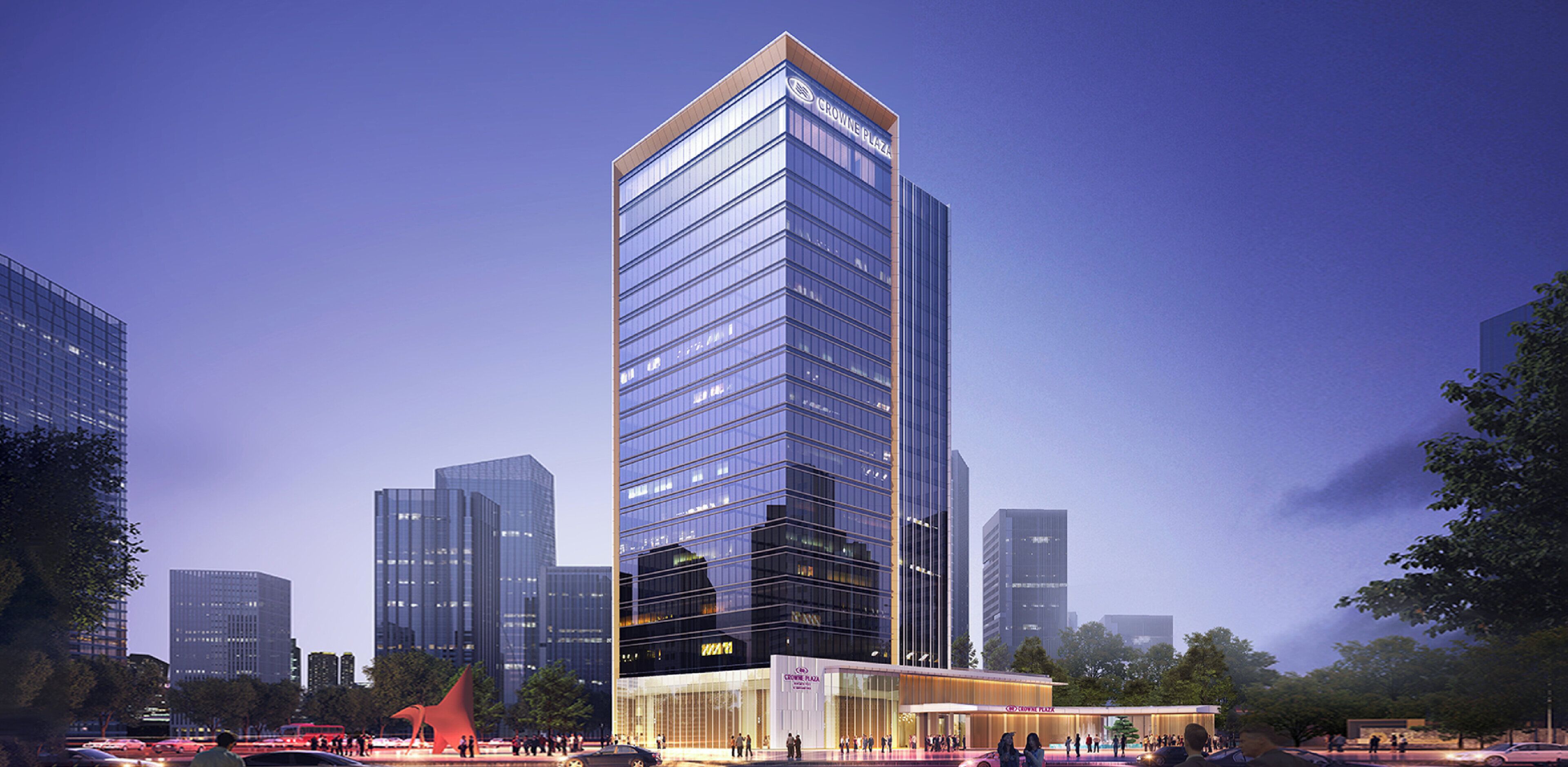 A modern high-rise hotel with a glass facade, a prominent entrance, and a surrounding urban environment.