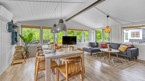 A spacious living area with a dining table, chairs, a sofa, and a TV. - "Valdemar" - 350m to the fjord by Interhome (Tarm)