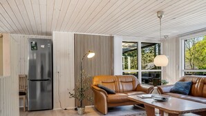 A modern kitchen with a built-in refrigerator, a wooden ceiling, and a large window. - "Siljan" -  from the sea by Interhome (Hals)
