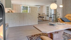 A modern interior with a kitchen, dining area, and living space. - "Siljan" -  from the sea by Interhome (Hals)