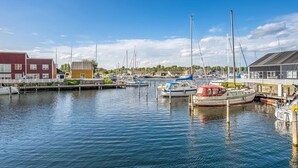A marina with boats docked, a red building, and a wooden structure. - "Milo" - 5m from the sea by Interhome (Ebeltoft)