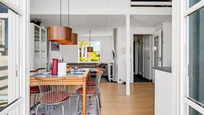 A modern interior with a dining area, a sofa, and a view of the outdoors. - "Milo" - 5m from the sea by Interhome (Ebeltoft)