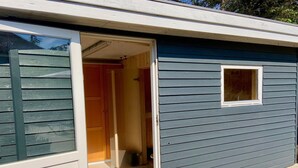 A single-story building with a sliding glass door entrance, a small window, and a tiled floor. - "Gudrid" - 500m from the sea by Interhome (Fanø)