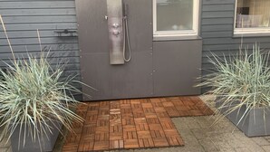 A modern exterior with a grey door, a small window, and two potted plants. - "Gudrid" - 500m from the sea by Interhome (Fanø)