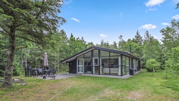 A modern glass house with a patio area, surrounded by a forested landscape. - "Chrissie" - 150m from the sea by Interhome (Hals)