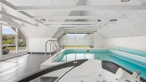 A modern indoor swimming pool with a clear view of the outdoors, a jacuzzi, and a sun terrace. - "Lidija" - 850m from the sea by Interhome (Ringkøbing)