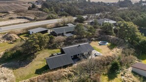 A modern building with a sloped roof, surrounded by trees and open fields. - "Gillis" - 900m from the sea by Interhome (Ringkøbing)