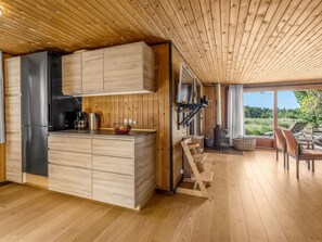 A modern kitchen with wooden cabinetry and a built-in stove.