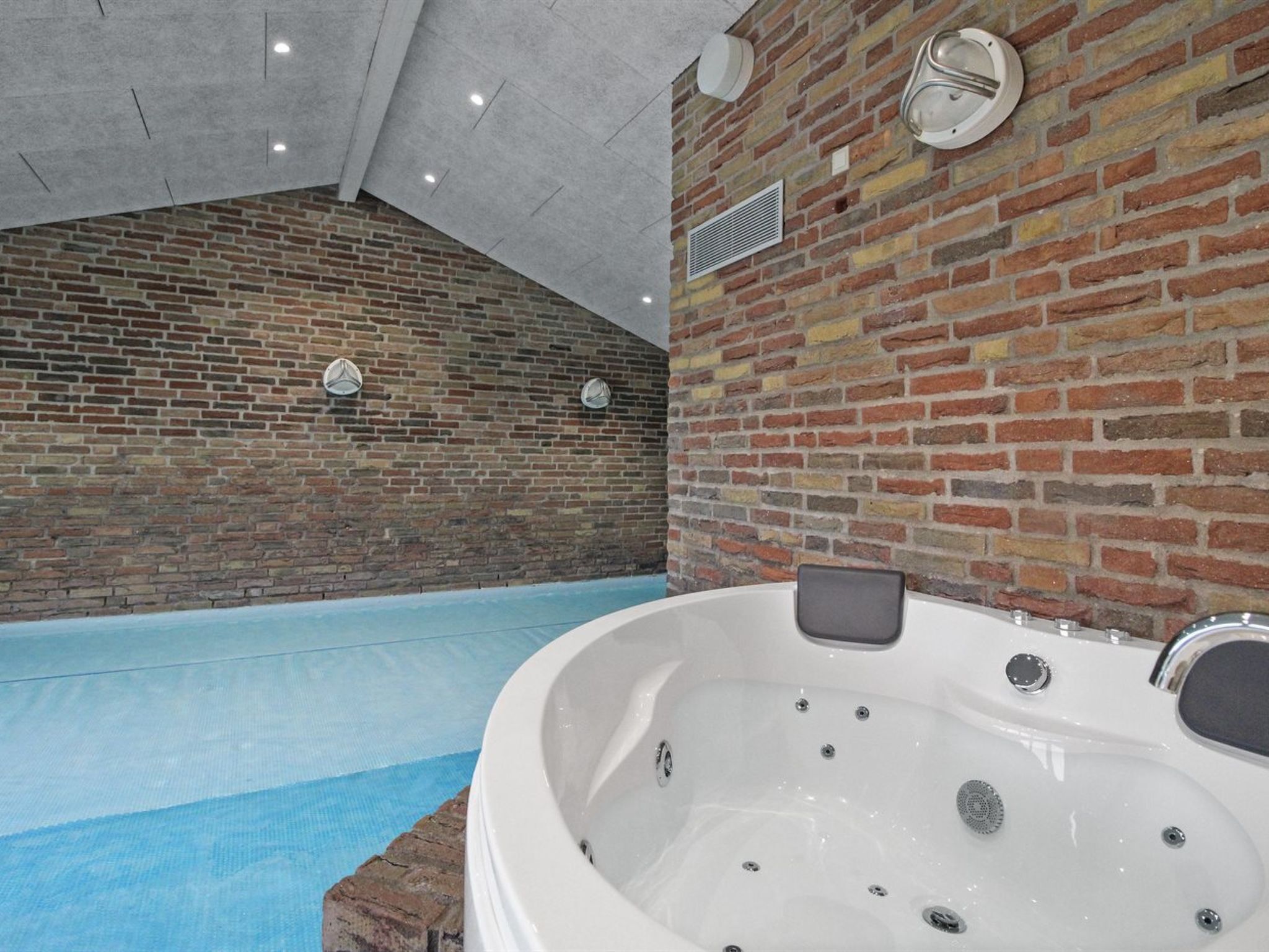 A spa area with a large indoor pool and a hot tub.