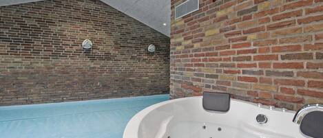 A spa area with a large indoor pool and a hot tub.