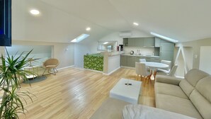 A modern loft apartment with a kitchen, dining area, and living room. - Comfort Apartments Pasha  (Budva)