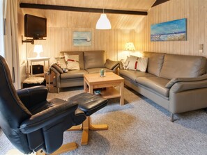A cozy living room with a sofa, two armchairs, a coffee table, and a TV mounted on the wall. - "Rentje" - 31km from the sea by Interhome (Toftlund)