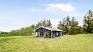 A single-story blue house with a gabled roof, large windows, and a small porch area. - "Mikkeline" - 400m to the fjord by Interhome (Øster Assels)