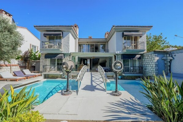 A two-story house with a swimming pool, a covered patio, and a stone facade. - Argente Alacatı Adult Only (Cesme)