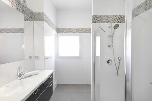 Shower, hair dryer, towels, toilet paper