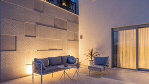 An outdoor seating area with a sofa and chairs, a small table, and a potted plant. - Modern Villa Callista - 3 bedroom luxury villa (Žrnovnica)