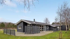 A modern farmhouse with a large barn, a covered patio, and a fenced yard. - "Andrea" - 1.4km from the sea by Interhome (Hals)
