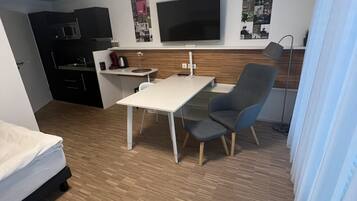 Basic Single Room | Living area | 50-inch Smart TV with cable channels