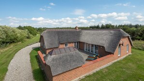 A large, single-story house with a steeply pitched roof, a gravel driveway, and a well-maintained lawn. - "Jorkin" - 1.8km from the sea by Interhome (Ulfborg)