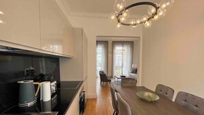 A modern kitchen with a dining area.