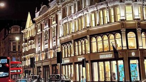 A brightly lit building with a storefront labeled "BURBERRY."