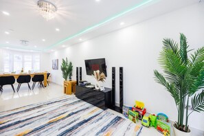 Enjoy a family-friendly living space with a large TV, dining area, and plenty of room for kids to play.