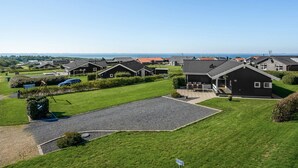 A residential area with modern houses, a clear sky, and a view of the sea. - "Brynjolf" - 350m to the fjord by Interhome (Vinderup)