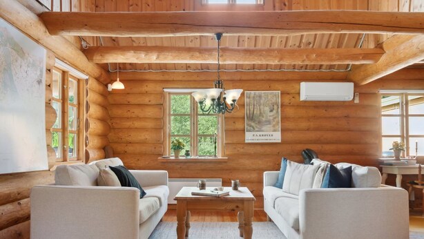 A log cabin interior with two sofas, a coffee table, and a chandelier. - "Elsia" - 1.5km to the fjord by Interhome (Frøstrup)