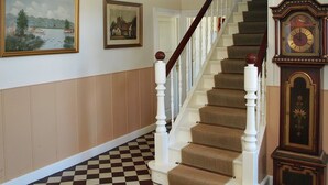 A staircase with a checkered floor, white balusters, and a wooden handrail. - "Thia" - 4km to the fjord by Interhome (Aabenraa)