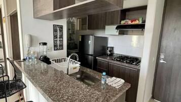 Fridge, oven, coffee/tea maker, cookware/dishes/utensils