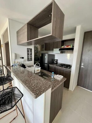 Fridge, oven, coffee/tea maker, cookware/dishes/utensils