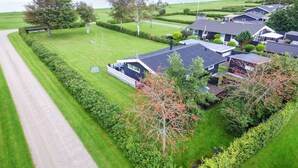 A residential area with houses, a well-maintained lawn, and a road. - "Ilya" - 90m to the fjord by Interhome (Storvorde)