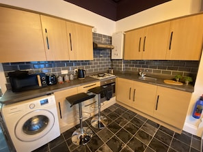 Enjoy cooking in this well-equipped kitchen with a sink, microwave, toaster, coffee maker, and dishwasher.