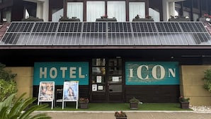 Un hotel con diseño moderno, paneles solares en el techo y un cartel con las palabras "HOTEL" e "ICON".