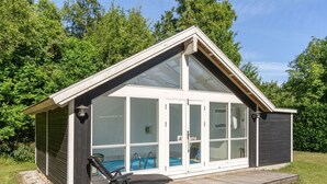 A modern house with a large glass front, a wooden deck, and a pool. - "Elita" - 1.7km from the sea by Interhome (Hals)