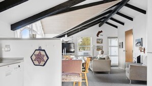 A modern kitchen with a built-in oven and a hexagonal wall decoration.
