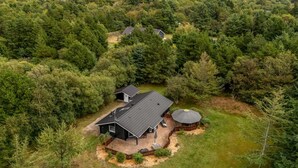 A house surrounded by dense forest with a clear view of the sky. - "Jorina" - 700m to the fjord by Interhome (Ringkøbing)