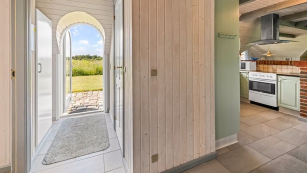 A hallway leading to a kitchen with a view of a green landscape. - "Vangja" - 700m to the fjord by Interhome (Hvide Sande)