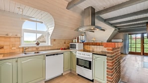 A kitchen with a built-in stove, a microwave, and a dishwasher. - "Vangja" - 700m to the fjord by Interhome (Hvide Sande)