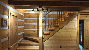 Eine Holztreppe mit Metallgeländer, die zu einer unteren Ebene führt.