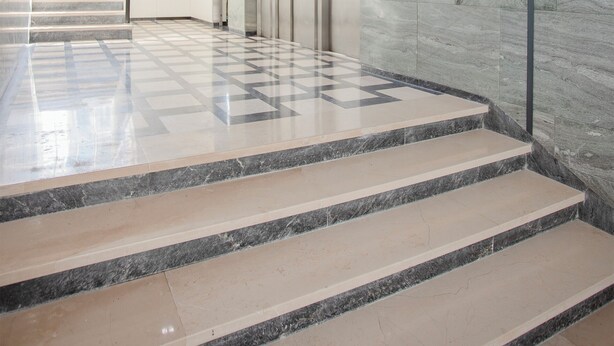 A modern interior with a marble staircase, a glass elevator, and a checkered floor pattern. - Allegro Boutique Apartment A (Porto)