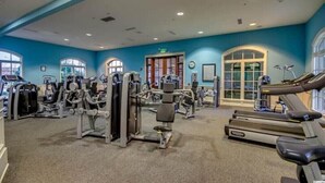 A gym with various exercise equipment, large windows, and a blue wall. - Luxury 3 Bedroom Villa @ N. Beach Resort - Walk to Everything! Beach/Pools/Food (North Myrtle Beach)