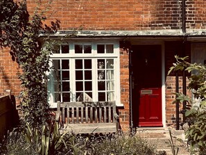 Step into a charming, historic abode with a traditional brick exterior and a cozy entrance.