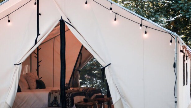 A tent with a bed, a table, and chairs inside. - Luxury Spacious Glamping, Lake View, Grill, Pool, Pet Friendly, Swim (Delta)