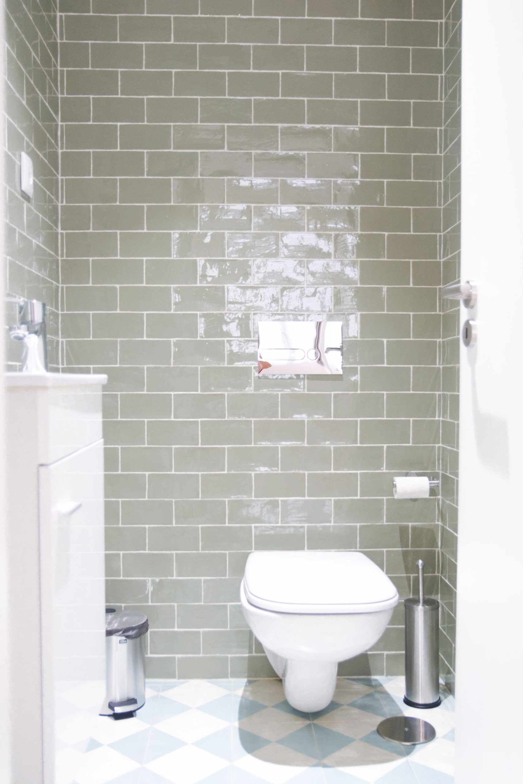Un baño con inodoro, cubo de basura y bidé.