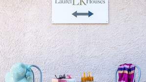 A table with a sign above it, two chairs, a hat, a book, and glasses. - Laurel LK Apt in Kremasti Near Airport Rhodes (Rhodes)