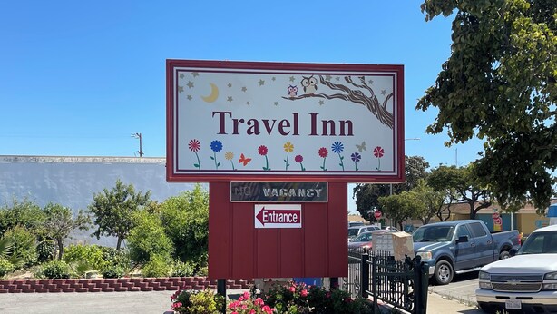 A Travel Inn sign with a moon, stars, and flowers. - Travel Inn (Greenfield)