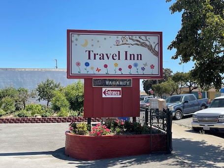 A Travel Inn sign with a moon, stars, and flowers.