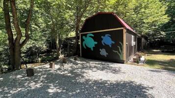 A building with a red roof and a mural of sea turtles on its side.