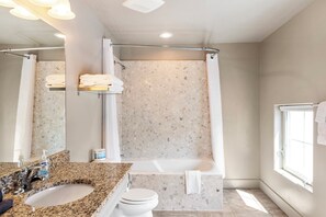 Enjoy a refreshing bath in the bathtub with a shower curtain.